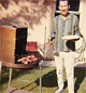 1960's man standing next to his barbeque